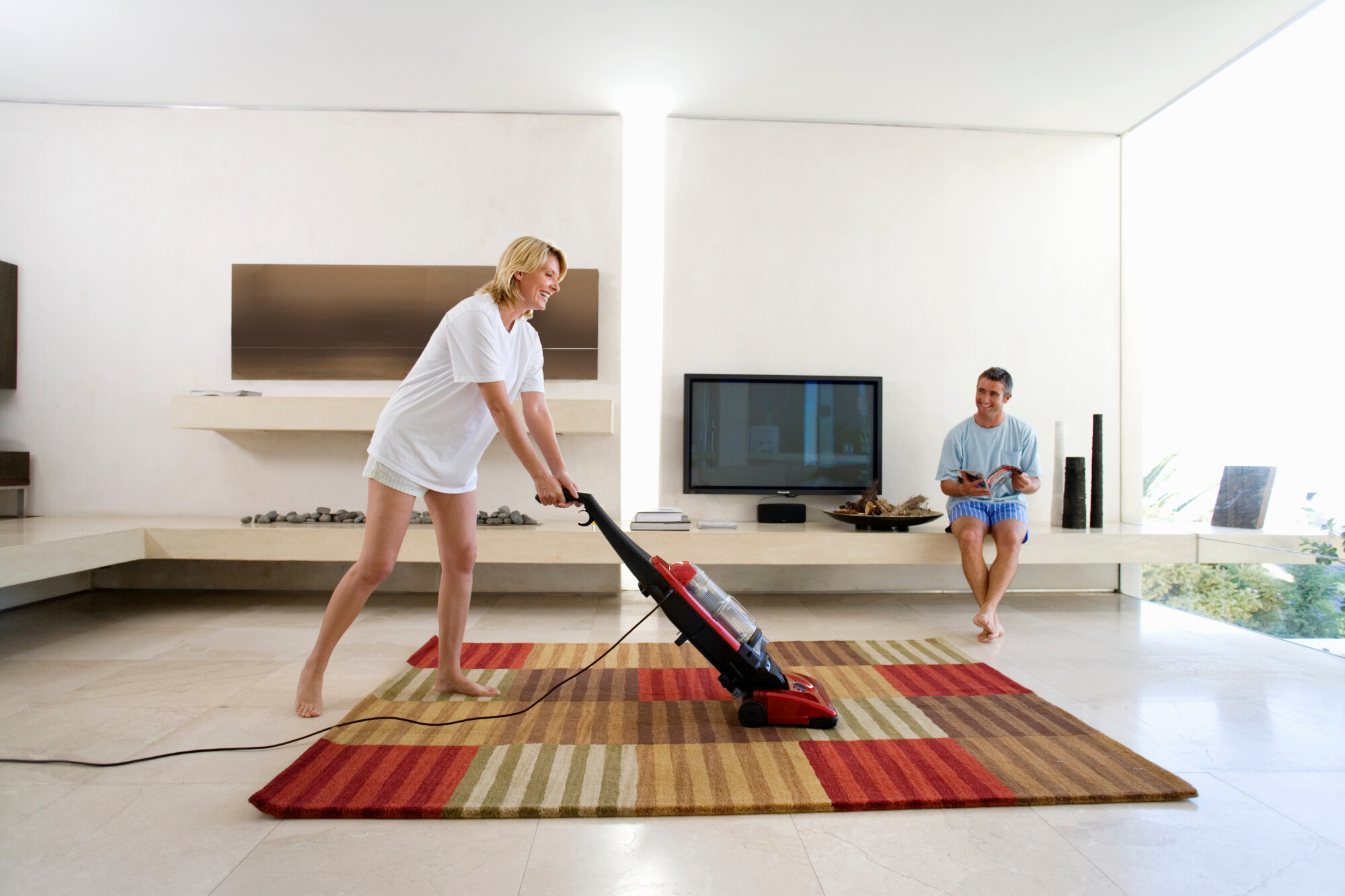 woman cleaning an oriental rug