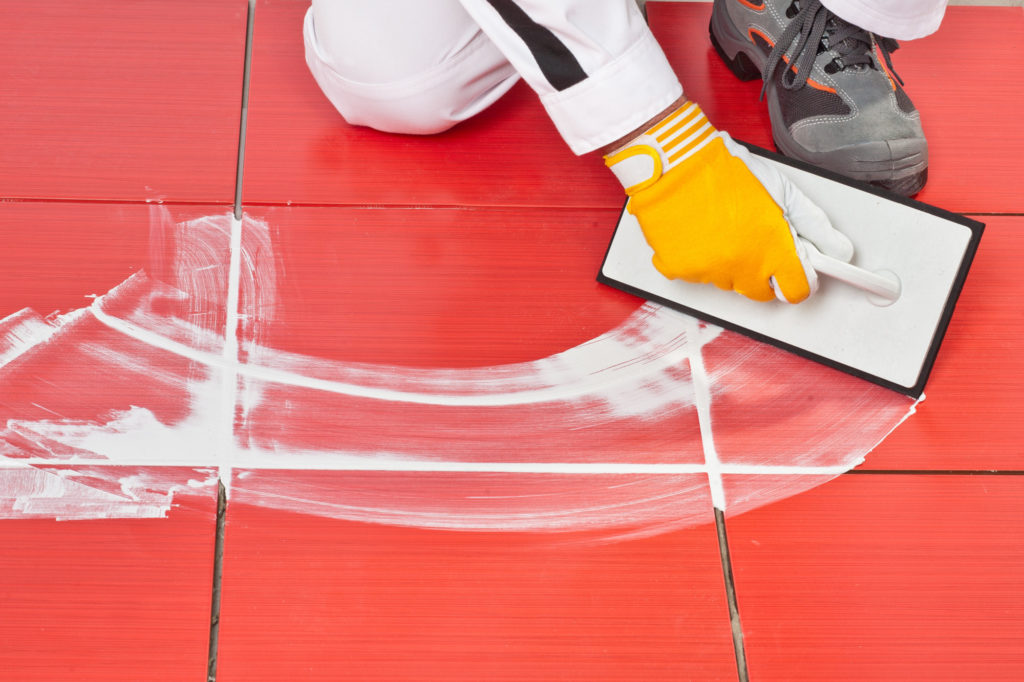 a man applying tile grout